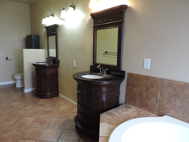 140 North 200 E Street Glenwood, UT 84730 - Photo 19 of 54 Full bathroom featuring two vanities, a garden tub, a textured wall, and light tile patterned floors