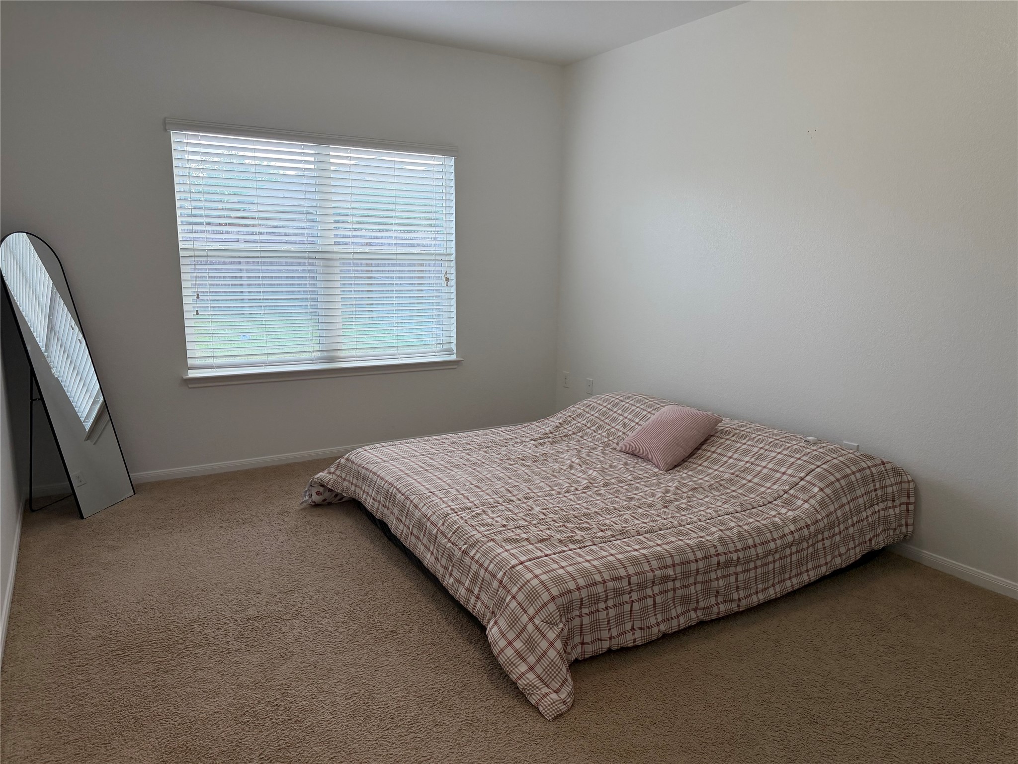 12111 Riprap Drive Manor, TX 78653 - Photo 5 of 14 a bedroom with a bed and window