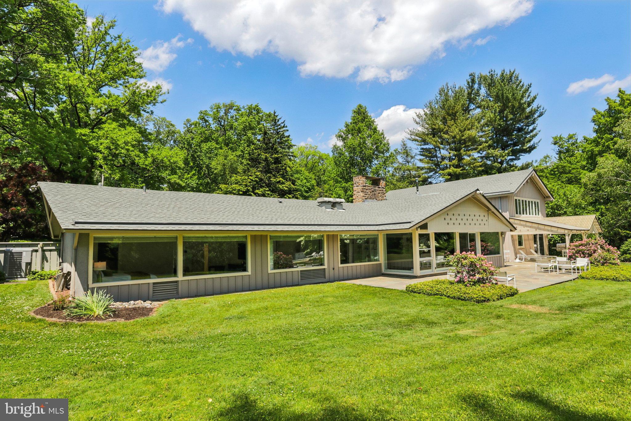 1673 Paper Mill Road Jenkintown, PA 19046 - Photo 59 of 73 a front view of a house with a yard table and chairs