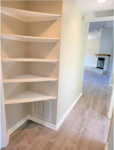 a view of an empty room with shelves