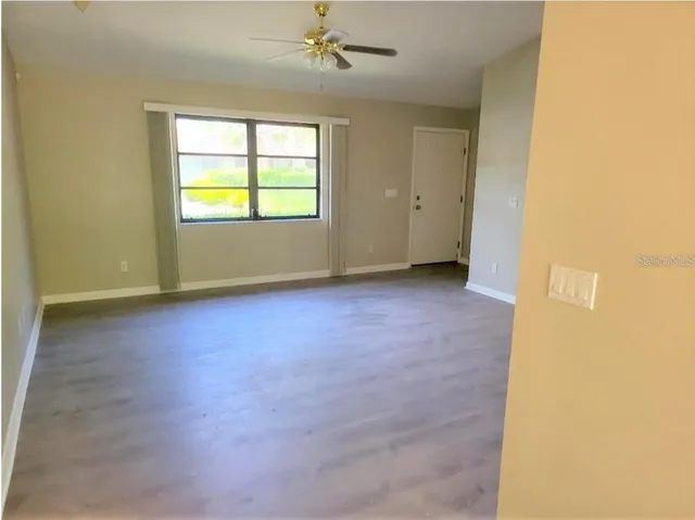 an empty room with windows and closet