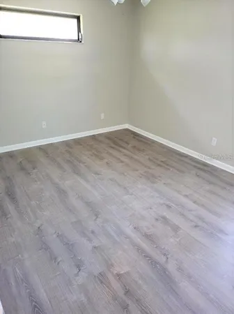 an empty room with wooden floor