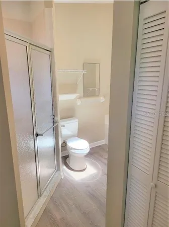 a bathroom with a toilet and a mirror