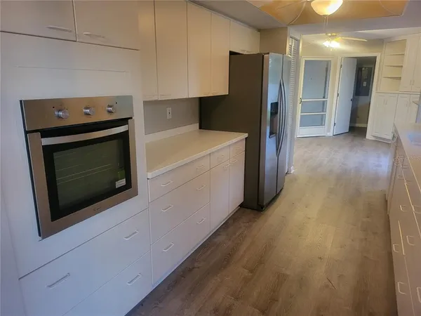 a kitchen with a refrigerator stove and cabinets