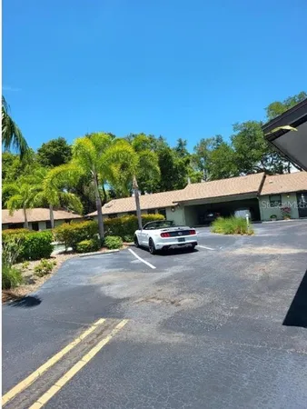 a view of a street with a car parked on the road