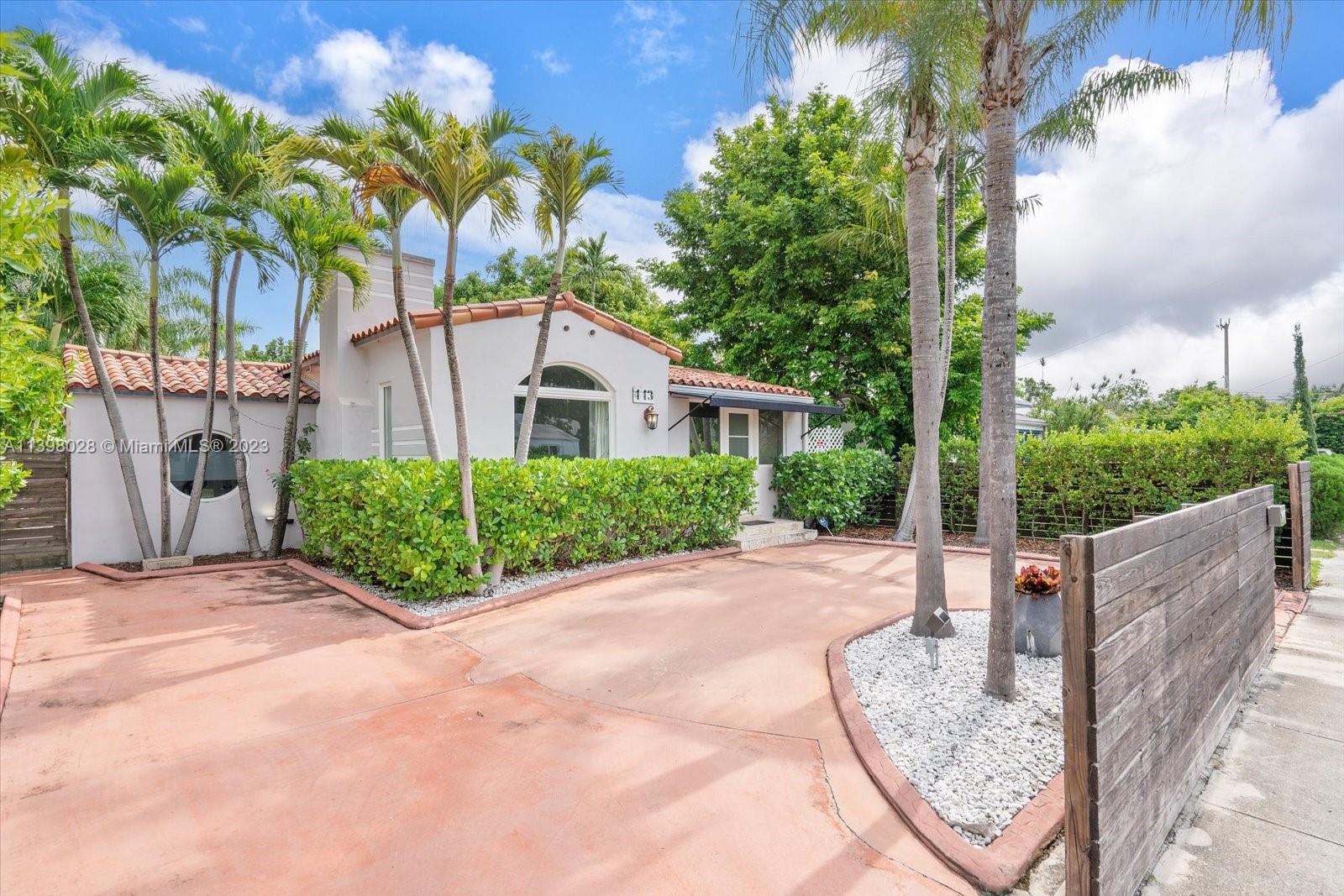 443 Northeast 71st Street Miami, FL 33138 - Photo 11 of 22 a house with a tree in front of it