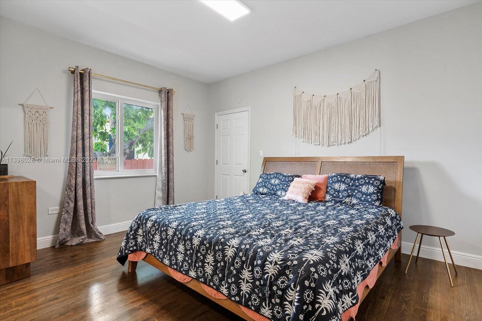 443 Northeast 71st Street Miami, FL 33138 - Photo 5 of 22 a bed sitting in a bedroom next to a window