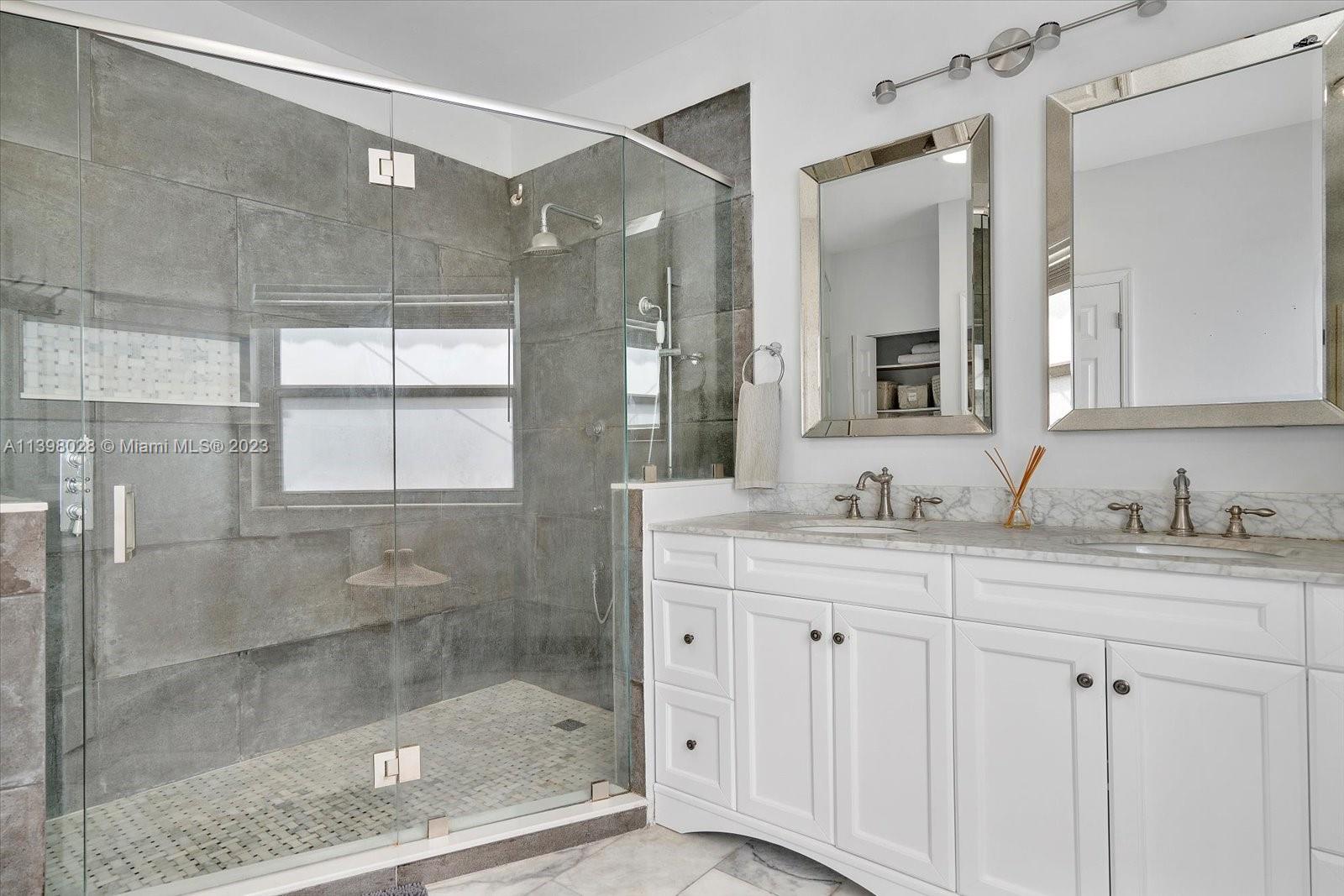 443 Northeast 71st Street Miami, FL 33138 - Photo 6 of 22 a bathroom with a shower sink and mirror
