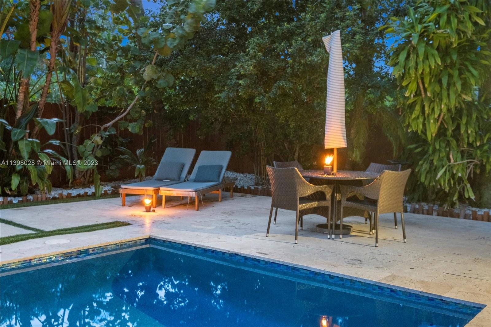 443 Northeast 71st Street Miami, FL 33138 - Photo 8 of 22 a view of a backyard with swimming pool and sitting area