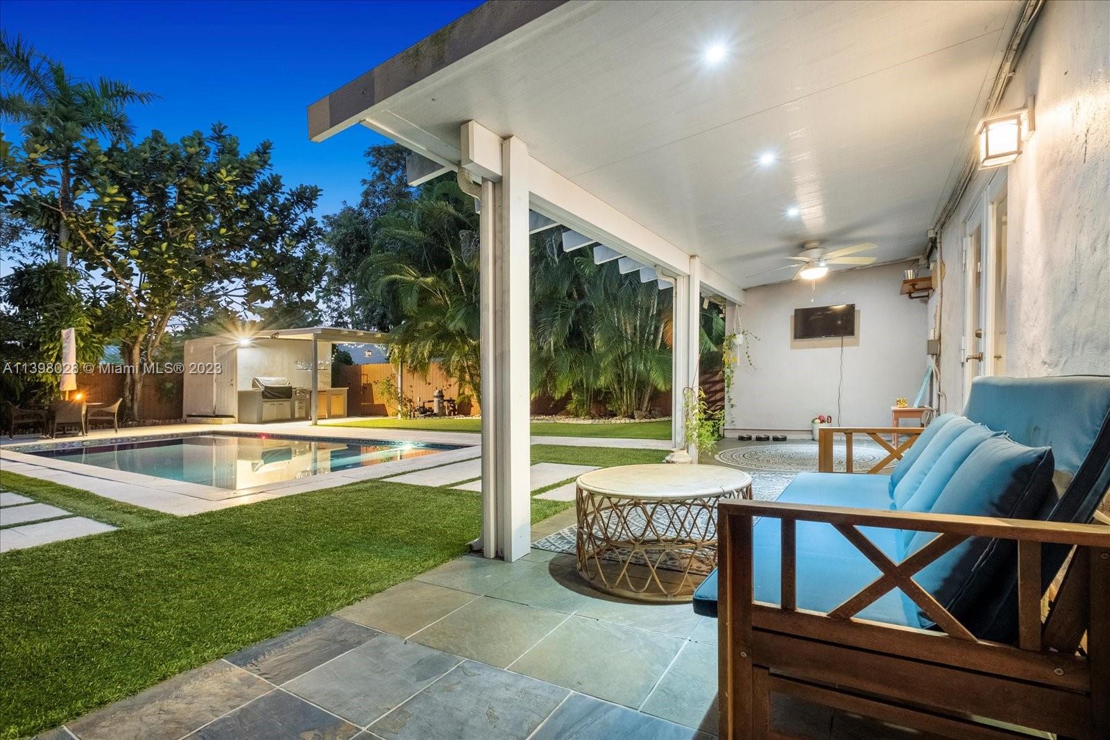 443 Northeast 71st Street Miami, FL 33138 - Photo 10 of 22 a view of a patio with table and chairs with plants and wooden fence
