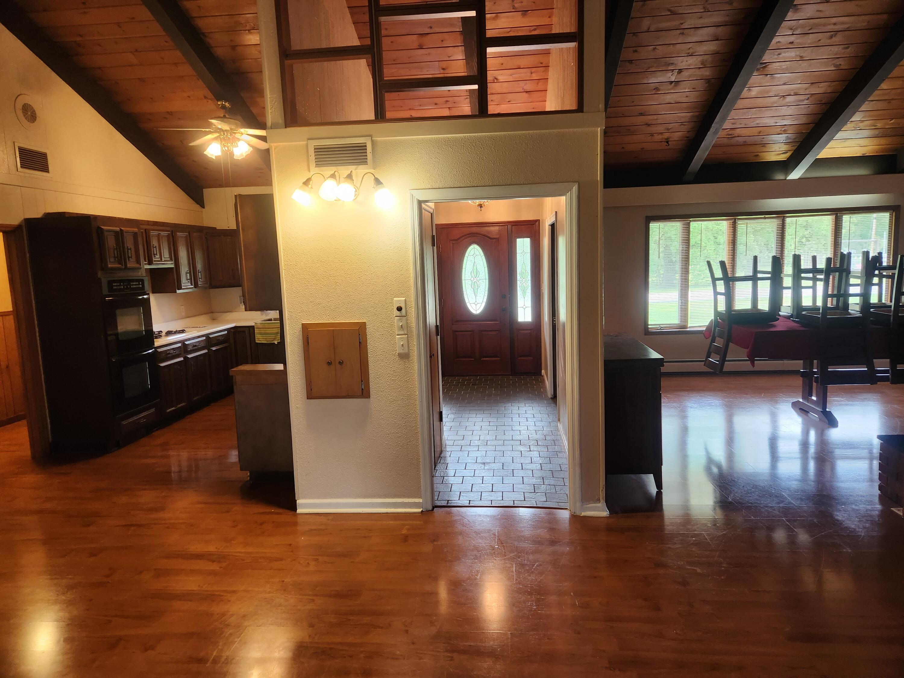 4726 Locksley Drive East Rensselaer, IN 47978 - Photo 11 of 33 a view of a living room with kitchen view and a wooden floor