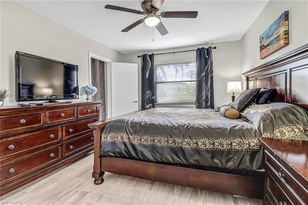 a bedroom with a bed and a flat screen tv