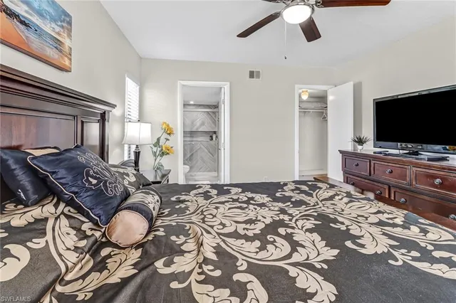 a bedroom with bed and tv