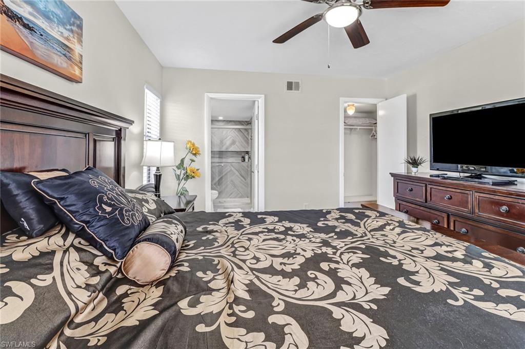 4166 27th Court Southwest, Unit 104 Naples, FL 34116 - Photo 17 of 25 a bedroom with bed and tv