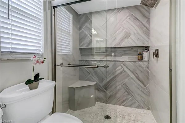 a bathroom with a toilet and a shower