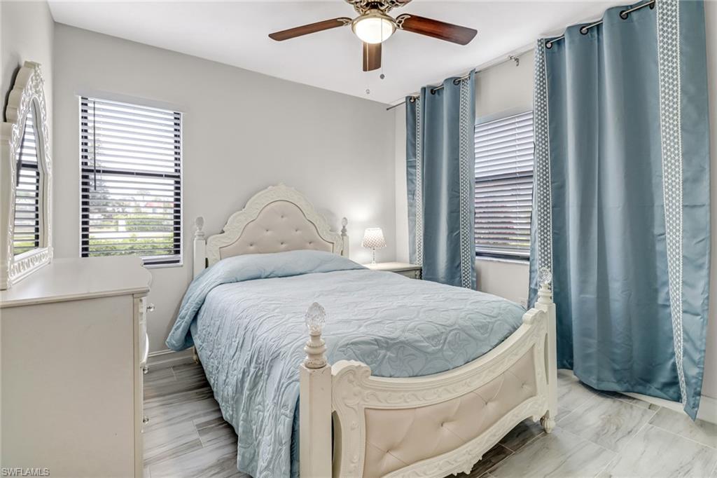4166 27th Court Southwest, Unit 104 Naples, FL 34116 - Photo 20 of 25 a bedroom with a bed and a window