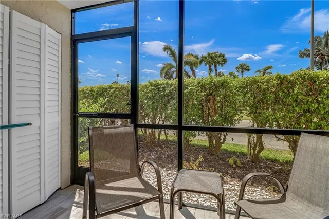a view of a balcony with chairs and a table
