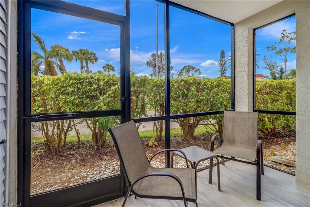 4166 27th Court Southwest, Unit 104 Naples, FL 34116 - Photo 25 of 25 a view of a chairs and table in a wooden floor