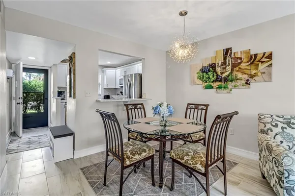 a view of a dining room with furniture and chandelier