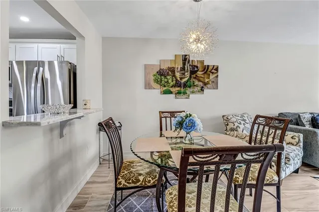 a view of a dining room with furniture and chandelier