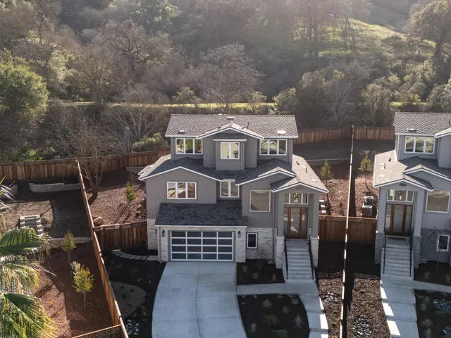 an aerial view of a residential apartment building with a yard
