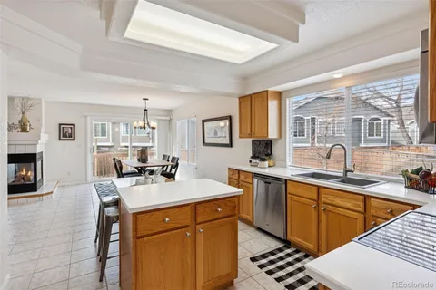 a very nice looking dining room with kitchen island a table and chairs in it