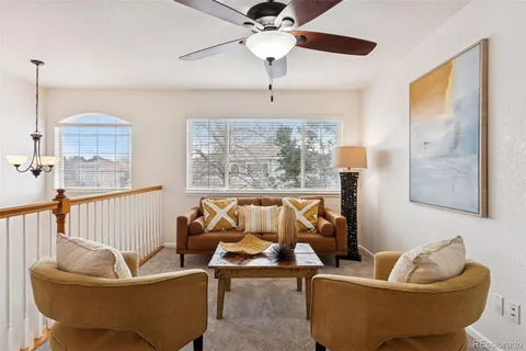 a living room with furniture and a chandelier