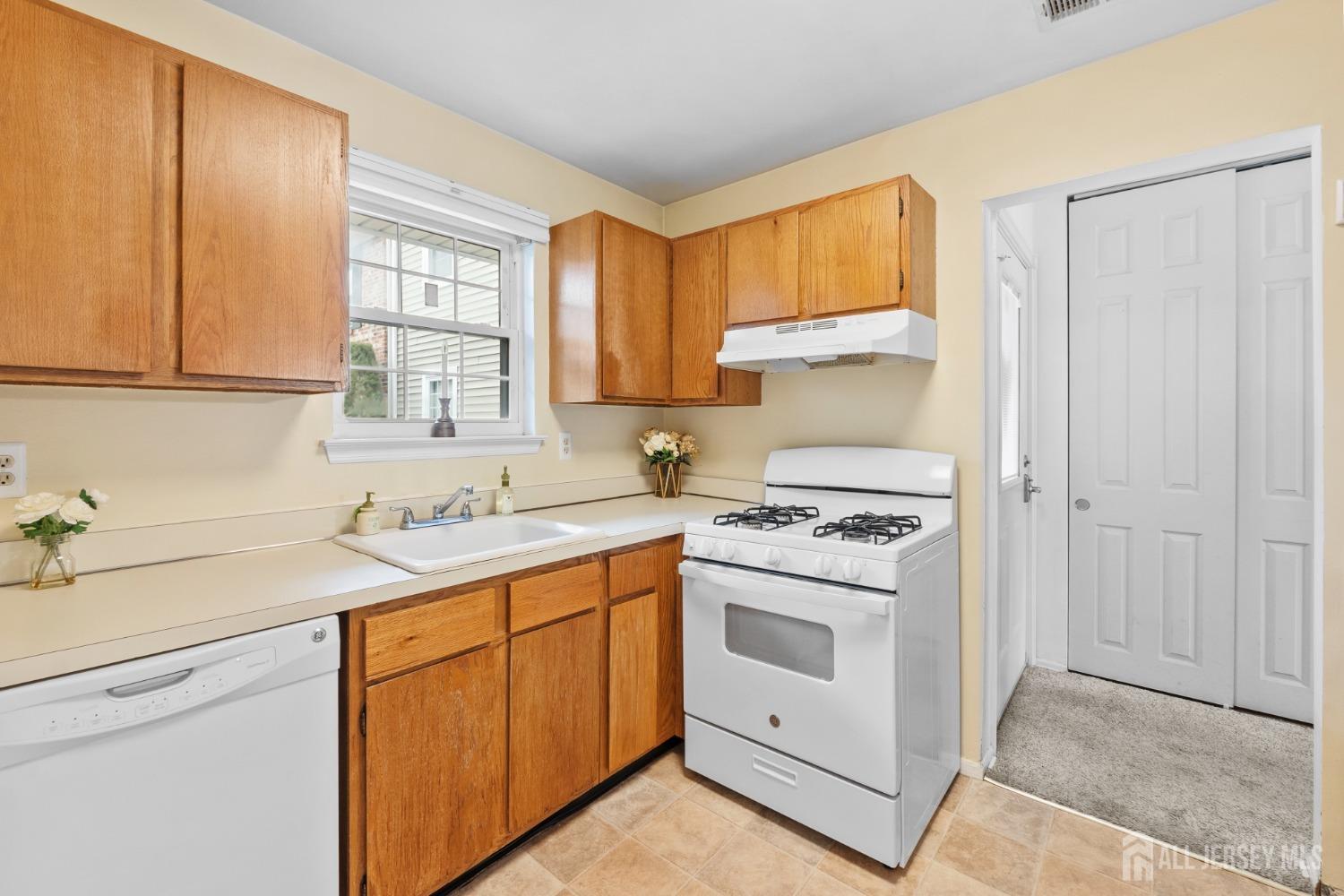 9 Lindsey Circle Old Bridge, NJ 08857 - Photo 14 of 23 a kitchen with a stove sink and cabinets