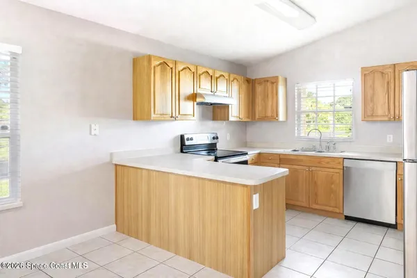a kitchen with a sink cabinets and window