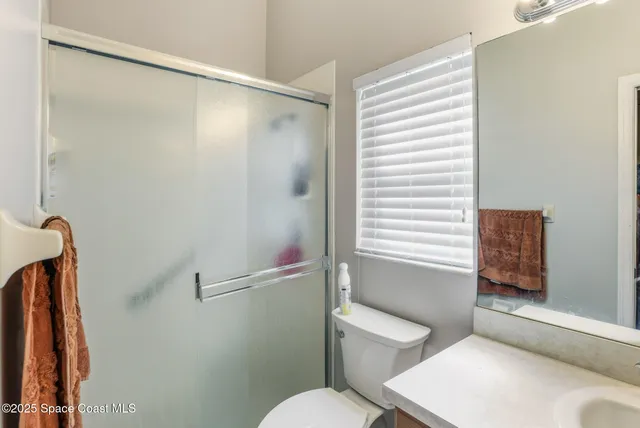 a white toilet sitting next to a bath tub