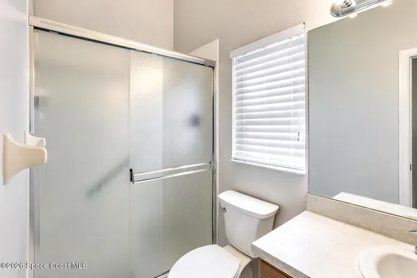 a white toilet sitting next to a bathroom sink
