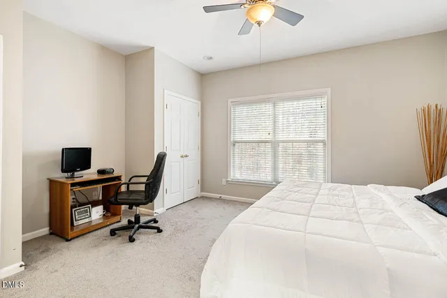 a bedroom with a large bed and a desk