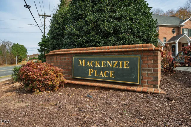 a sign that is sitting on a brick wall