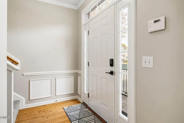 a view of a bedroom with wooden floor and bathroom