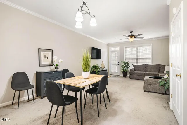 a view of a livingroom and a dining room with furniture window and wooden floor