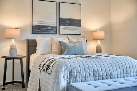 a bedroom with a bed and a lamp with window