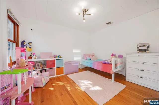 a bed room with a bed and a dresser