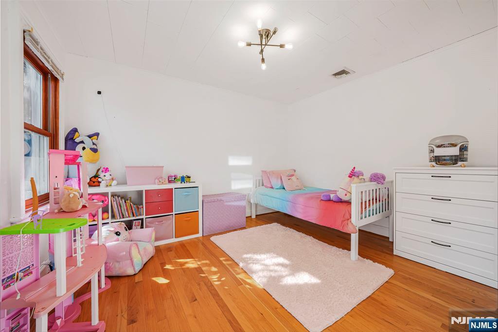 36 Clara Street North Haledon, NJ 07508 - Photo 11 of 31 a bed room with a bed and a dresser