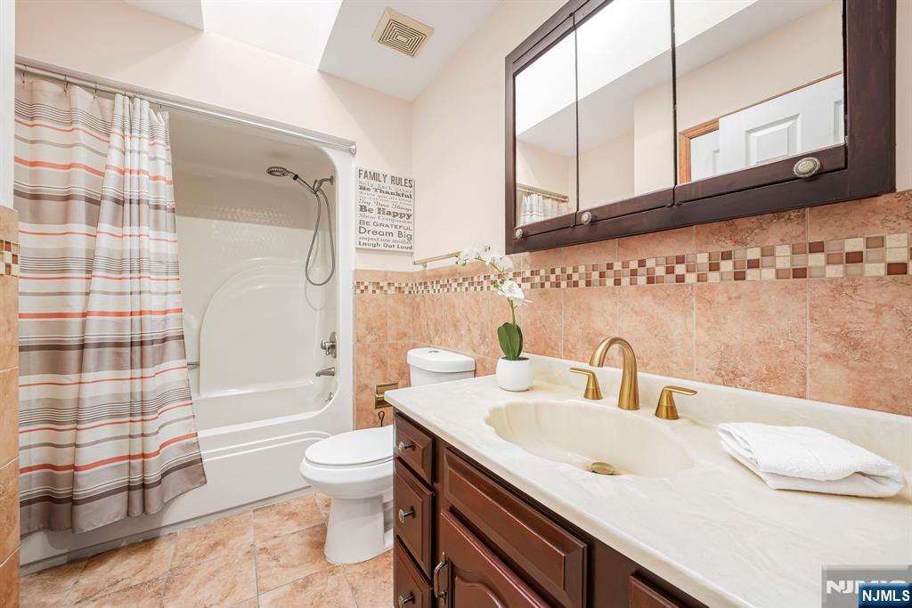 36 Clara Street North Haledon, NJ 07508 - Photo 12 of 31 a bathroom with a sink and a mirror