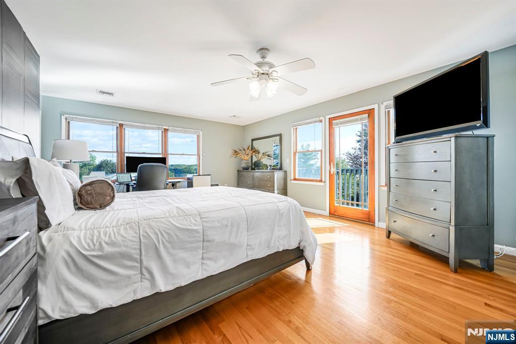 36 Clara Street North Haledon, NJ 07508 - Photo 20 of 31 a spacious bedroom with a bed and a flat screen tv