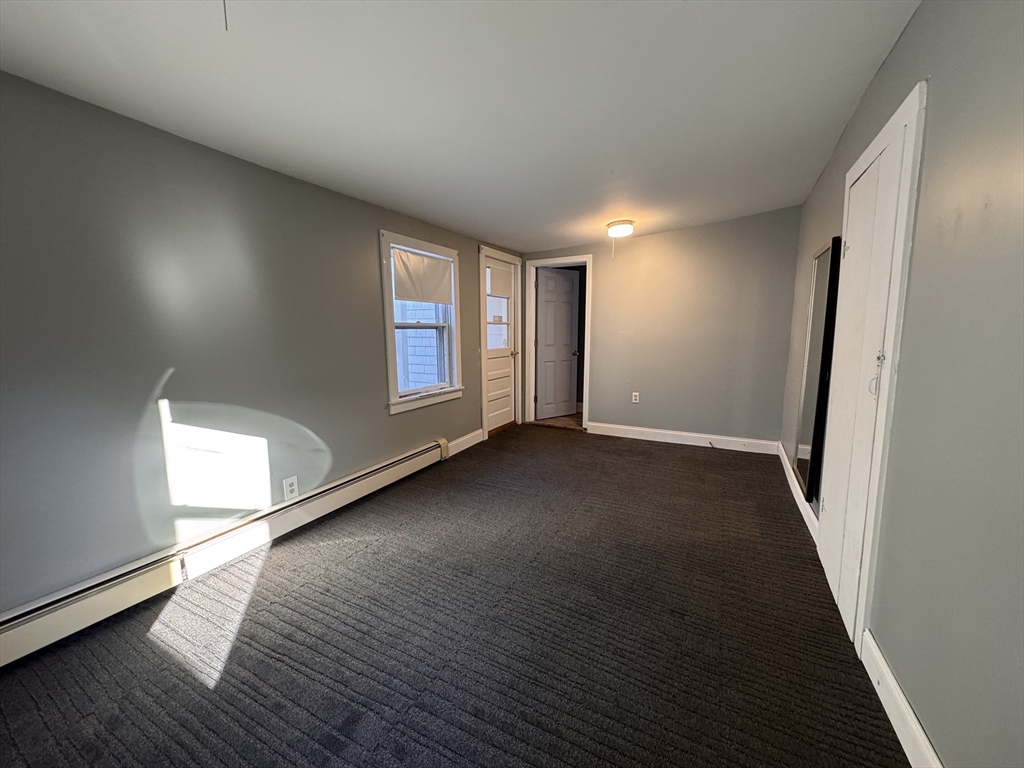 258 Walnut Street, Unit 1 Bridgewater, MA 02324 - Photo 11 of 19 an empty room with wooden floor and windows