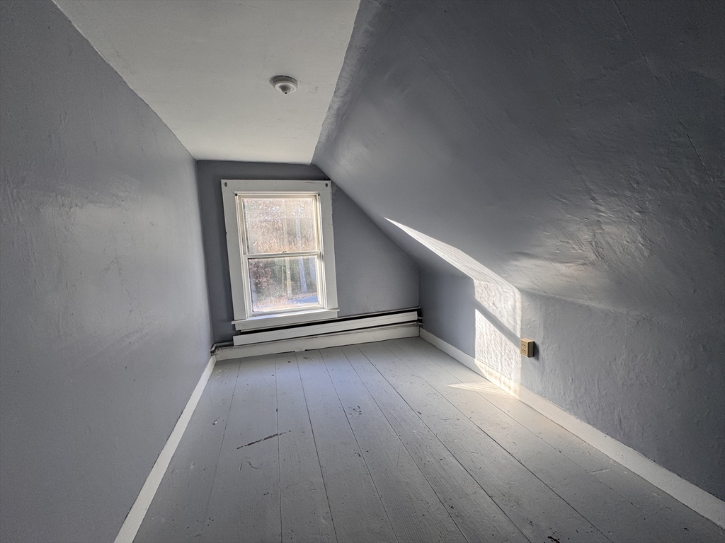 258 Walnut Street, Unit 1 Bridgewater, MA 02324 - Photo 16 of 19 an empty room with wooden floor and windows