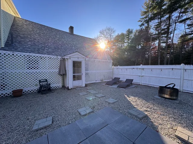 a view of a backyard with table and chairs