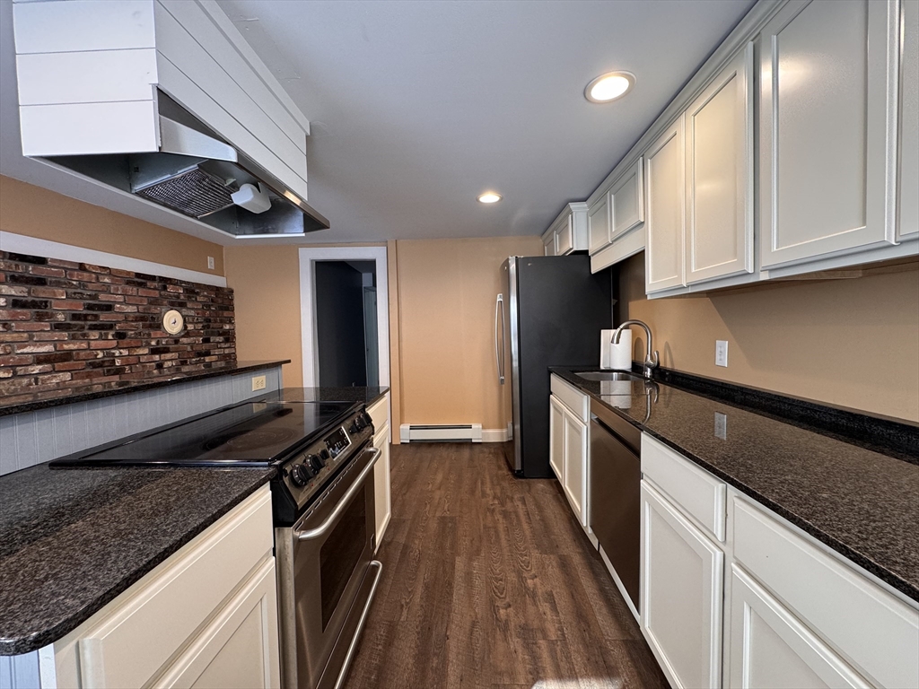 258 Walnut Street, Unit 1 Bridgewater, MA 02324 - Photo 8 of 19 a kitchen with stainless steel appliances granite countertop a stove a sink and a microwave