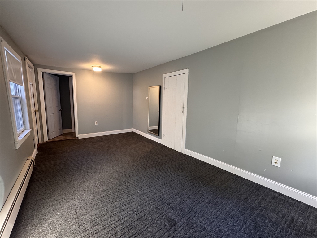 258 Walnut Street, Unit 1 Bridgewater, MA 02324 - Photo 10 of 19 an empty room with wooden floor and windows