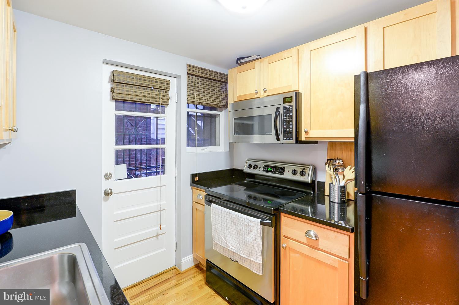 1737 P Street Northwest, Unit 201 Washington, DC 20036 - Photo 12 of 15 a kitchen with granite countertop a refrigerator and a sink