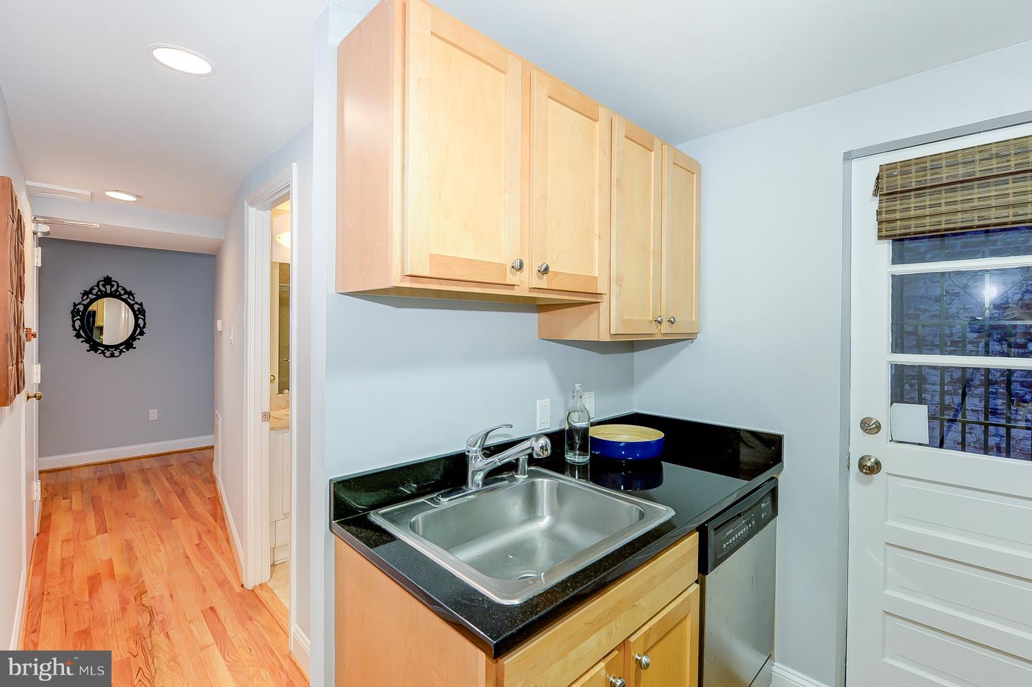 1737 P Street Northwest, Unit 201 Washington, DC 20036 - Photo 13 of 15 a kitchen with stainless steel appliances granite countertop a sink and a cabinets