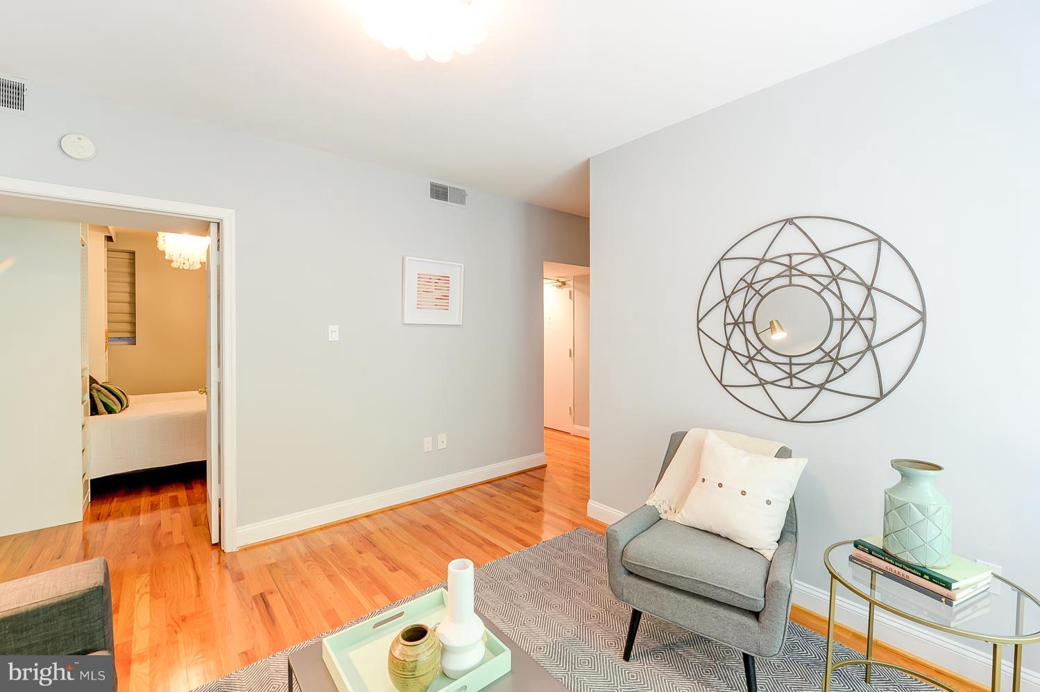 1737 P Street Northwest, Unit 201 Washington, DC 20036 - Photo 4 of 15 a bedroom with a bed and wooden floor