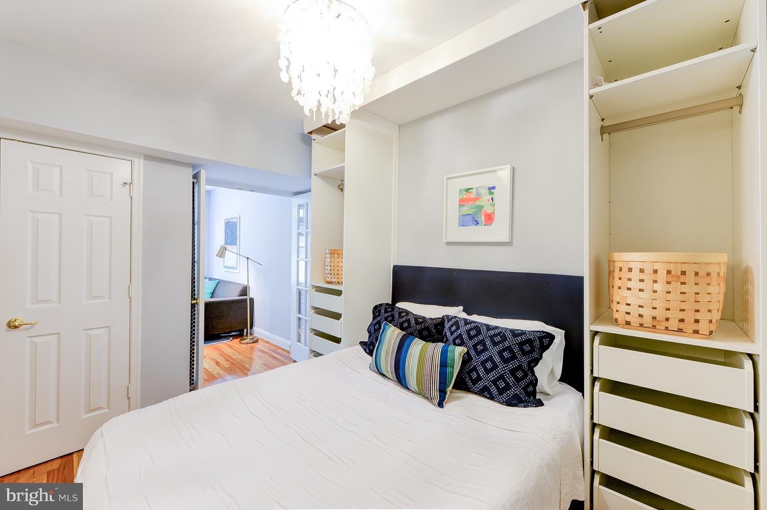 1737 P Street Northwest, Unit 201 Washington, DC 20036 - Photo 9 of 15 a large bedroom with a large bed and a chandelier