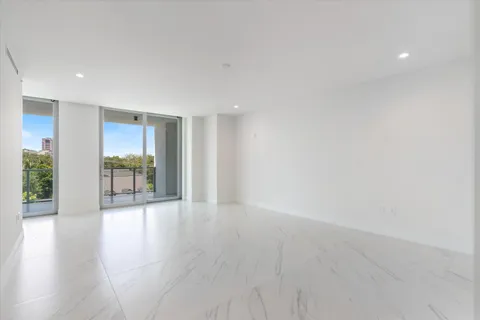 an empty room with windows and closet